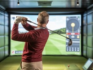 Golf Lessons Pepper Pike: golfer swings driver in simulator bay